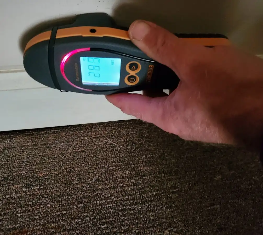 Moisture detection at baseboard during Storm Damage Restoration in Wyndham